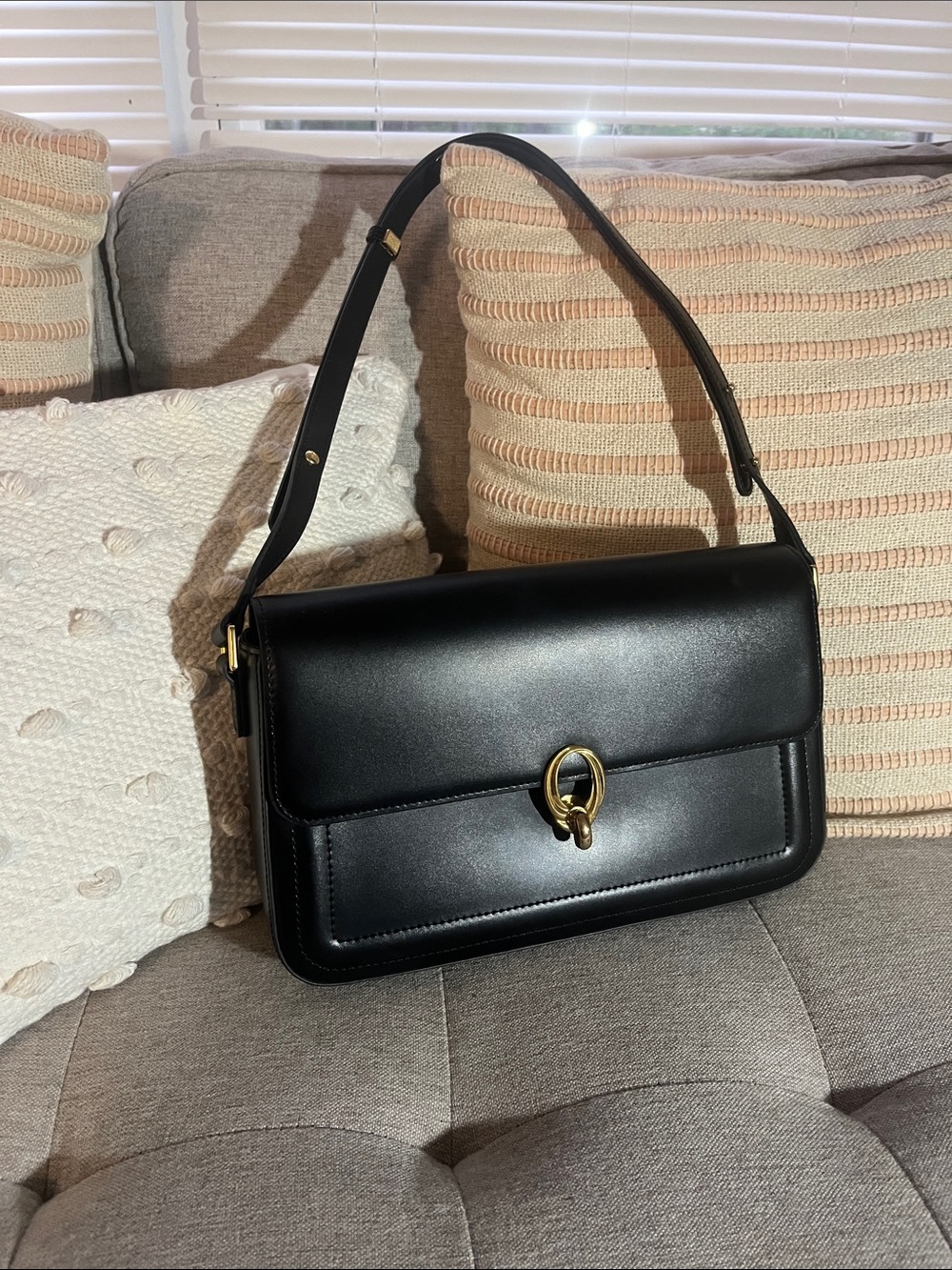 Classic Black Leather Shoulder Bag with Gold Ring Accent